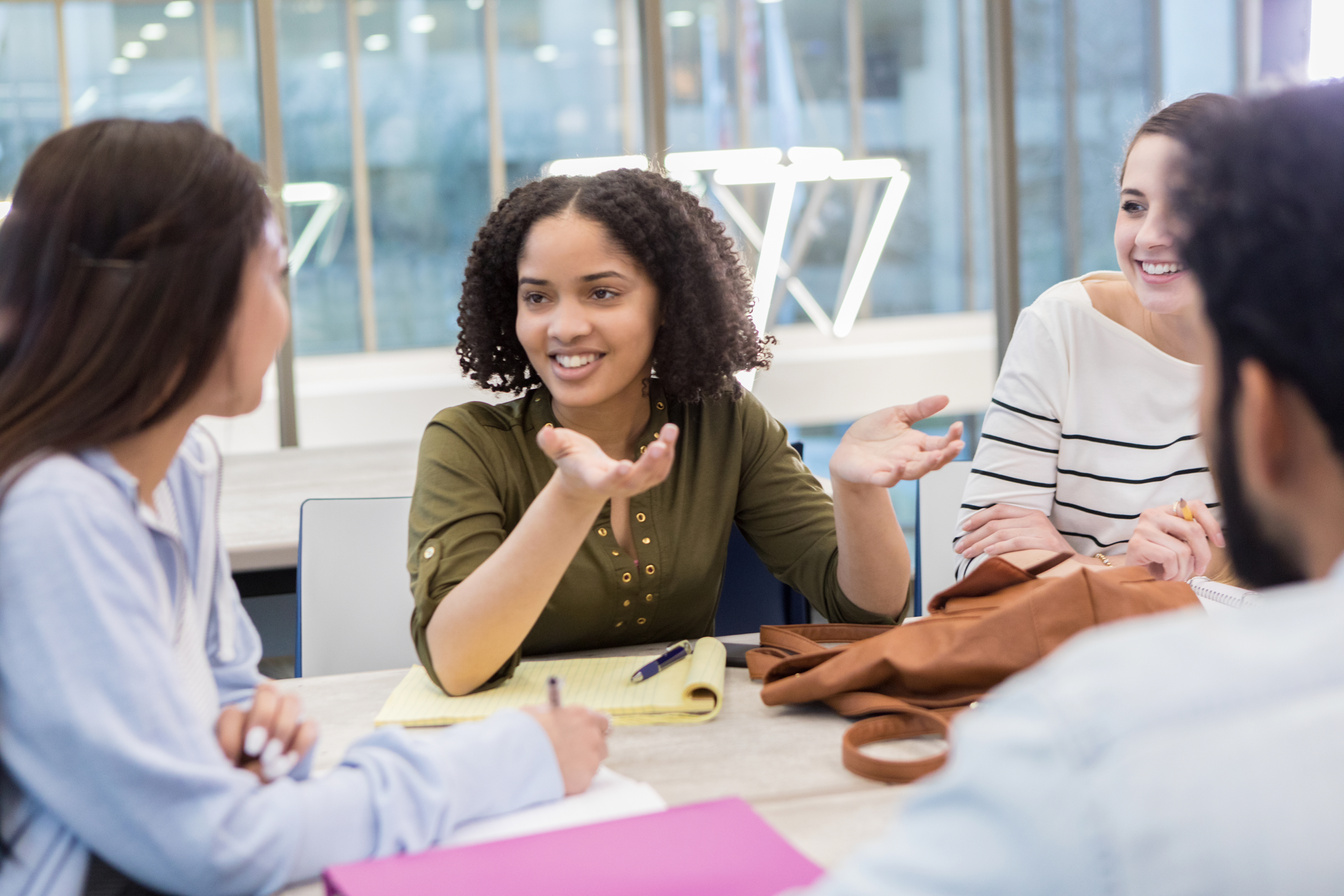 Young woman speaks to college study group